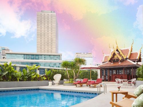 a pool with a view of a city at Montien Hotel Surawong Bangkok in Bangkok