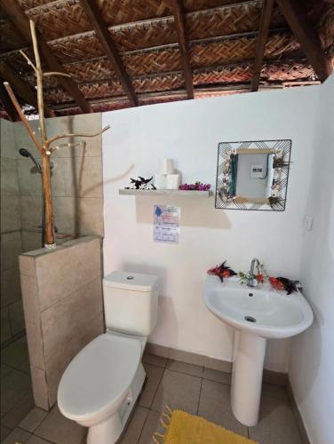 a bathroom with a toilet and a sink at Tikehau Herearii in Tikehau Airport