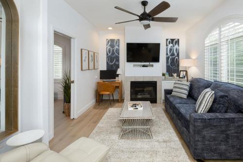 a living room with a blue couch and a tv at Luxury At Pier Avenue in Oceano
