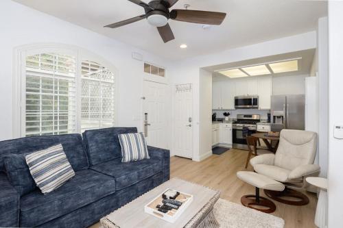 a living room with a blue couch and a kitchen at Luxury At Pier Avenue in Oceano