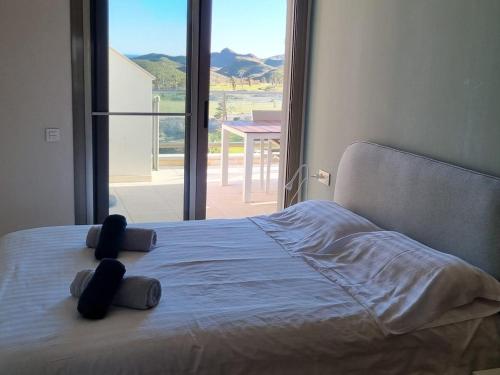 a bed in a bedroom with a large window at Apartamento cómodo, terraza - 4 pers. - ES-376-48 in Pulpí