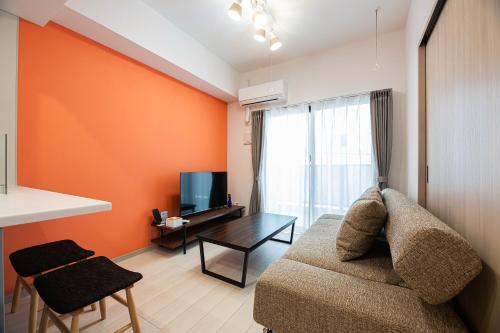 a living room with a couch and a table at SPAZIO 4 Tenjin Minami in Fukuoka