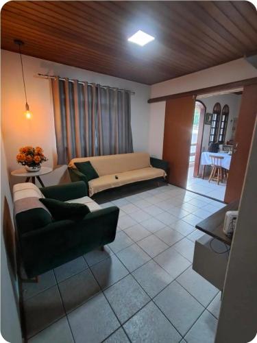 a living room with a couch and a table at Canto dos pássaros in Volta Redonda