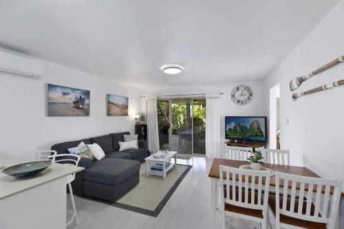 a living room with a couch and a table at Applecross - Perfect For A Weekend Escape in North Avoca