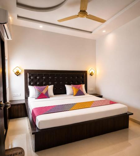 a bedroom with a large bed with a black headboard at La Buddha Villagers Homestay - Near Taj Mahal Agra in Agra