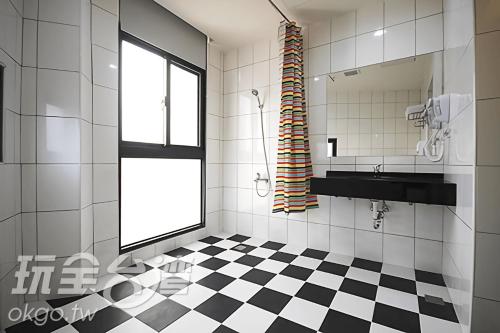 a bathroom with a black and white checkered floor at CoCo Motel Boutique in Puli