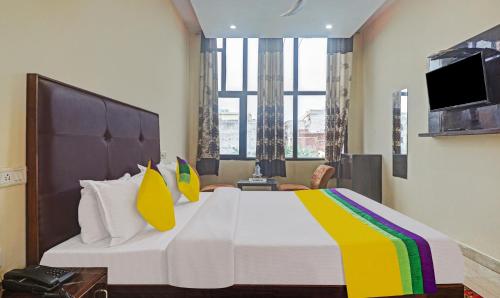 a bedroom with a large bed and a tv at Hotel Albie Stay,Near Railway Station Chandigarh in Chandīgarh