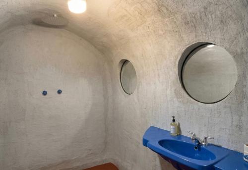 a bathroom with a blue sink and a mirror at Mr Lapin in Santiago Sacatepéquez