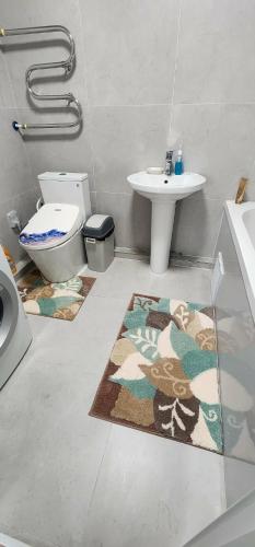 a bathroom with a toilet and a sink at "Private Room in New Luxury " Apartment in Ulaanbaatar