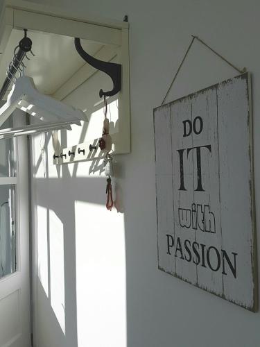 a do it with passion sign hanging on a wall at Zsigmond Vendégház in Villány