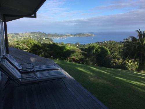 a view of the ocean from the porch of a house at Nikau Apartments Waiheke Island in Onetangi