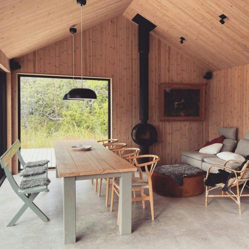 a dining room with a table and chairs and a couch at Architect-Designed House In Etelhem, Gotland in Stånga