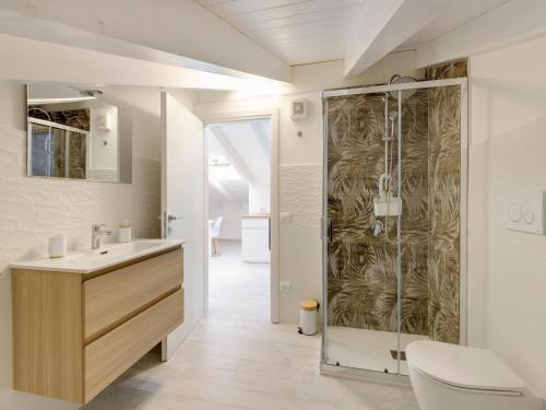 a bathroom with a shower and a sink at Brand new attic studio apartment, air conditioned in Castelsardo