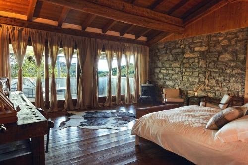 a bedroom with a bed and a stone wall at Ancient Monastery In The Lariani Mountains in Cernobbio