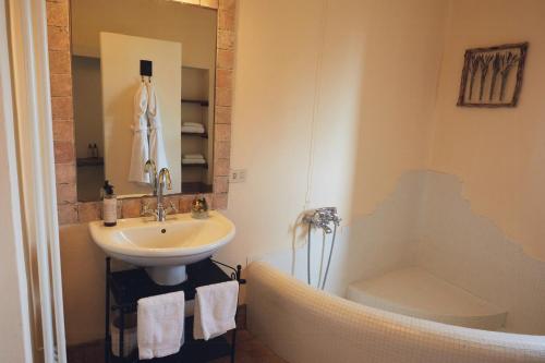 a bathroom with a sink and a toilet and a shower at Ancient Monastery In The Lariani Mountains in Cernobbio