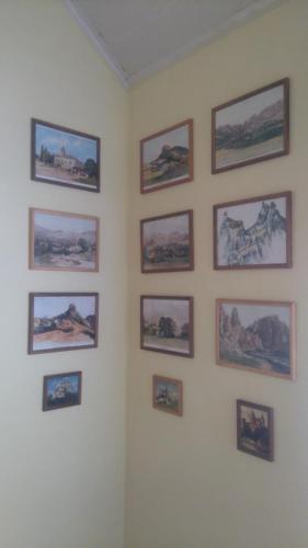 a wall with pictures on a white wall at Apartmány Súľov 183 in Súľov