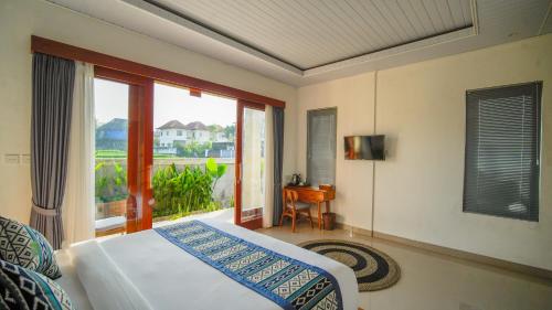 a bedroom with a bed and a window with a view at Bale Sidi House Ubud in Ubud