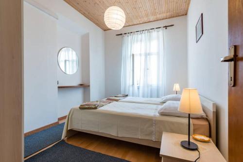 a bedroom with a bed and a table with a lamp at Apartments LIMA Lazaneo in Jelsa