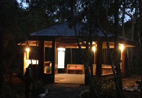 a gazebo at night with a bench and lights at Cuyinco Domos in Riñinahue