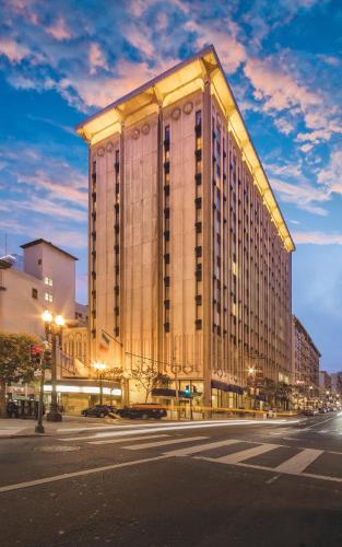 a large building on a city street at night at The Donatello Resort Studio Apartment in San Francisco