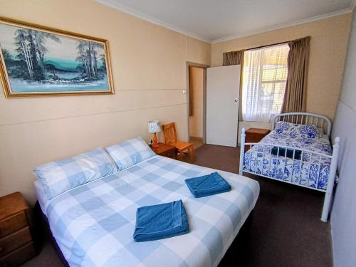 a hotel room with two beds and a window at Lakes Entrance Holiday Units in Lakes Entrance