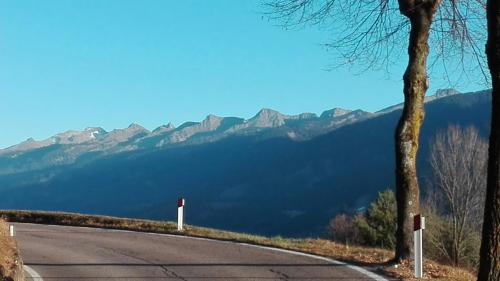 an empty road with mountains in the background at Maso Franceschella in Carano