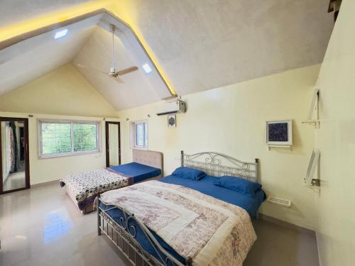 a bedroom with two beds in a room at Spellbound in Wadgaon