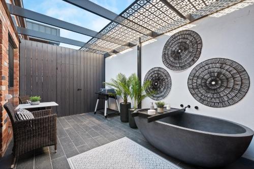 a bathroom with a large tub and windows at Marine Cove in Yarrawonga