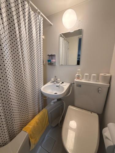 a bathroom with a white toilet and a sink at 水戸第一ホテル本館 in Mito