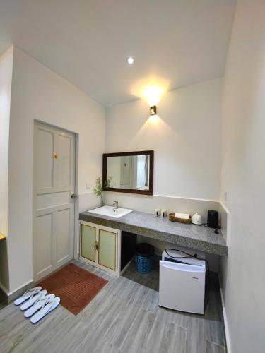 a bathroom with a sink and a mirror at Kampot Origin in Kampot