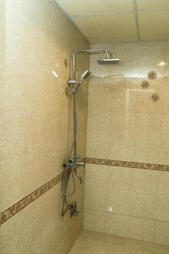 a bathroom with a shower with a shower head at Samaraham Residency in Indāf
