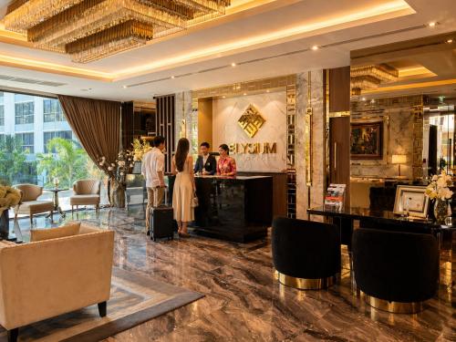 a group of people standing in a hotel lobby at The Elysium Prațumnak Pattaya - By SHG in Pattaya South