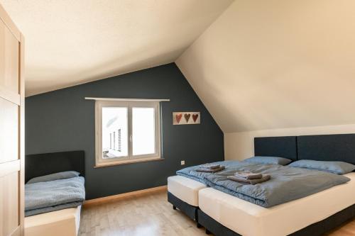 a bedroom with a large bed and a window at Steinbockblick Maienfeld in Maienfeld