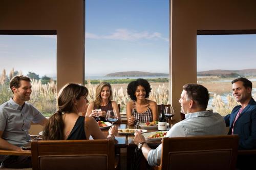 a group of people sitting around a table in a restaurant at The Lodge at Bodega Bay in Bodega Bay