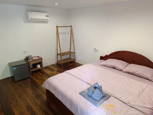 a bedroom with a bed with a towel on it at Stay in Paradise Koh Rong in Koh Rong Island