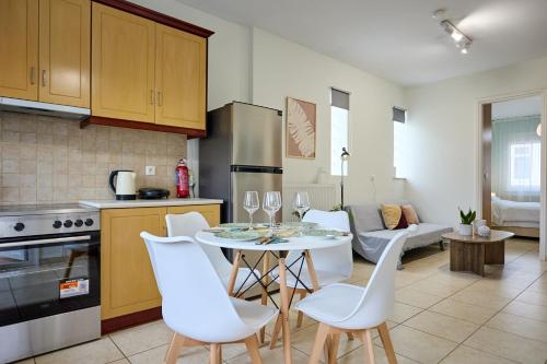a kitchen and living room with a table and chairs at Bella Casa Chios in Chios