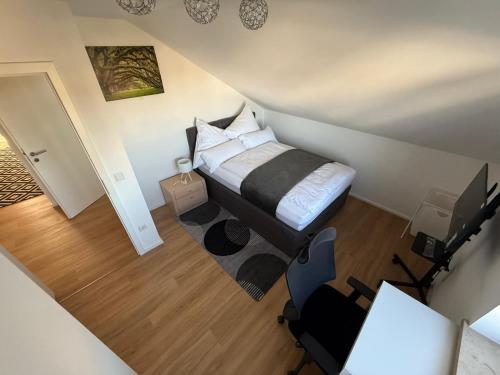 an overhead view of a bedroom with a bed and a desk at Toukam's Apartment, near Ingolstadt in Stammham