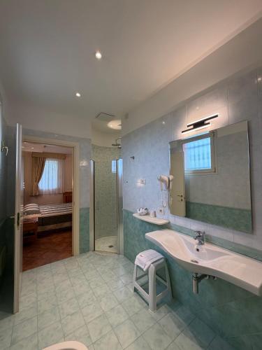 a bathroom with a sink and a mirror and a shower at Cà Rocca Relais in Monselice
