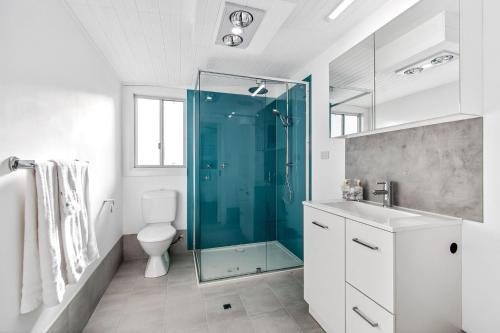 a bathroom with a glass shower and a toilet at Bilpin Station in Bilpin