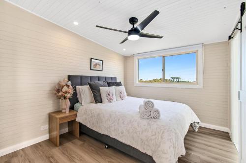 a bedroom with a bed and a ceiling fan at Bilpin Station in Bilpin