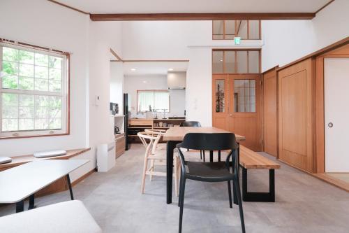 a kitchen and dining room with a table and chairs at rinne 伊豆 Private Spa in Ito