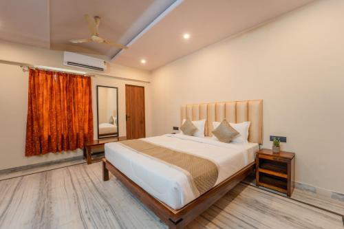 a bedroom with a large bed and a window at The Amber House - Luxury Boutique Stay in Bani Park, City Center Jaipur in Jaipur