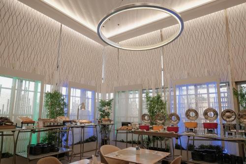 a room with tables and chairs and a chandelier at Ramada by Wyndham Manila Central in Manila