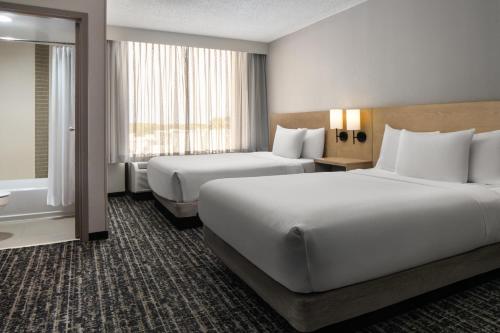 a hotel room with two beds and a window at Hyatt Place Richmond - Innsbrook in Short Pump