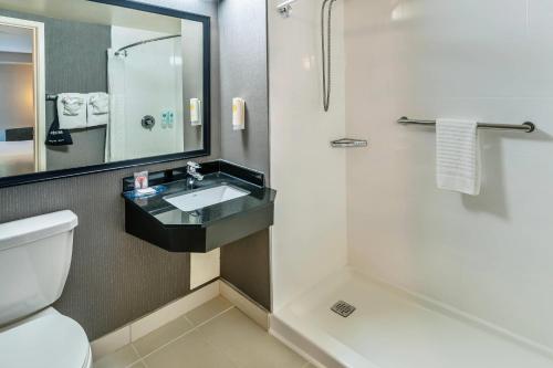a bathroom with a toilet and a sink and a shower at Comfort Inn Sudbury East in Sudbury