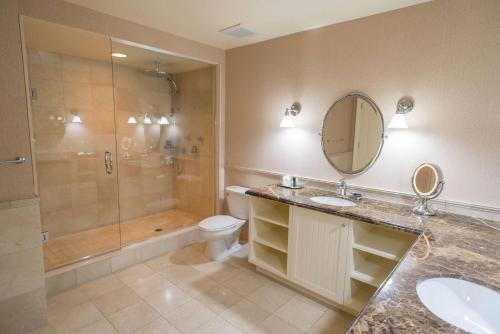 a bathroom with a sink and a shower and a toilet at Rawley Resort, Spa & Marina, Trademark Collection by Wyndham in Port Severn