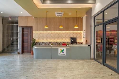 a restaurant with a counter in a room at Treebo Imperia, Kommadi in Visakhapatnam