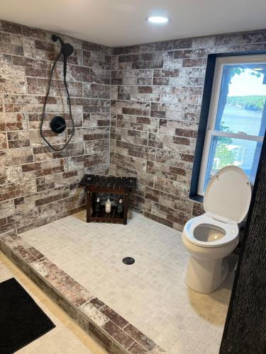 a bathroom with a shower and a toilet at Rising Sun Rustic Retreat in Roach