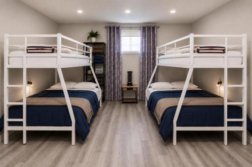 a bedroom with two bunk beds with blue and white at Tuscan Ridge Guesthouse Calgary West in Calgary