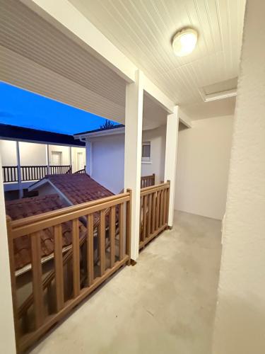an empty house with a porch with a deck at Studio cosy proche bordeaux avec balcon in Villenave-dʼOrnon